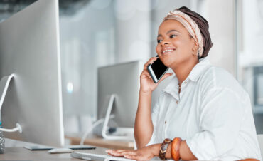 Communication, conversation and black woman on a phone call while working on a computer. Contact, c.
